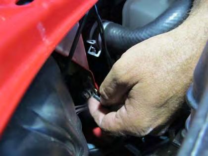 5. Next to left fender of vehicle, secure the ring terminal with two black wires to the