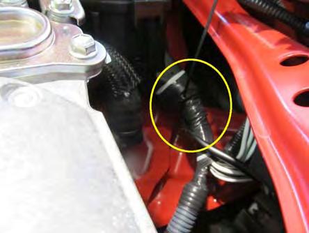 Route the wire harness following the path of the hood release cable: from engine