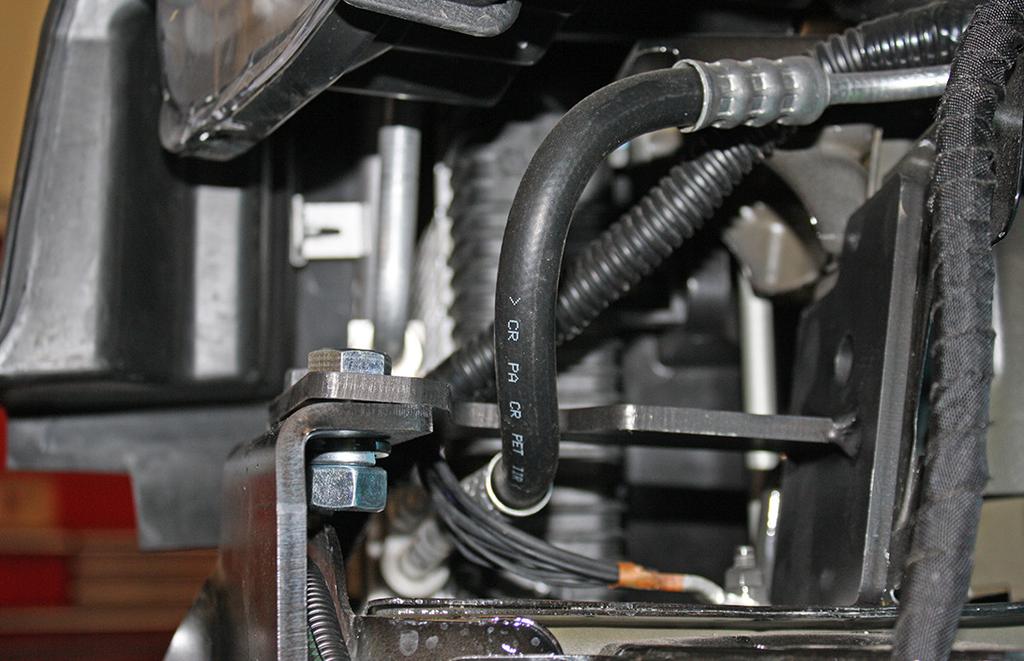 Use four of the supplied zip ties (two doubled up) to attach the wiring harness to the main receiver brace and two zip ties to attach the ambient temperature