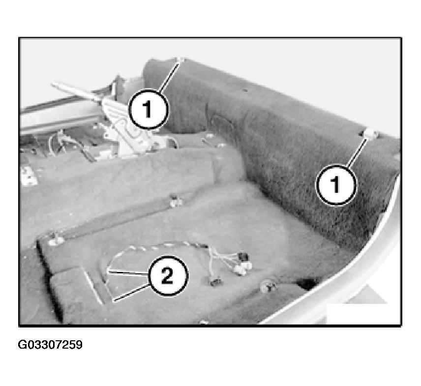 Fig. 21: Locating Carpet Locators Unfasten plug connection (1) and disconnect. Unscrew nuts (2).