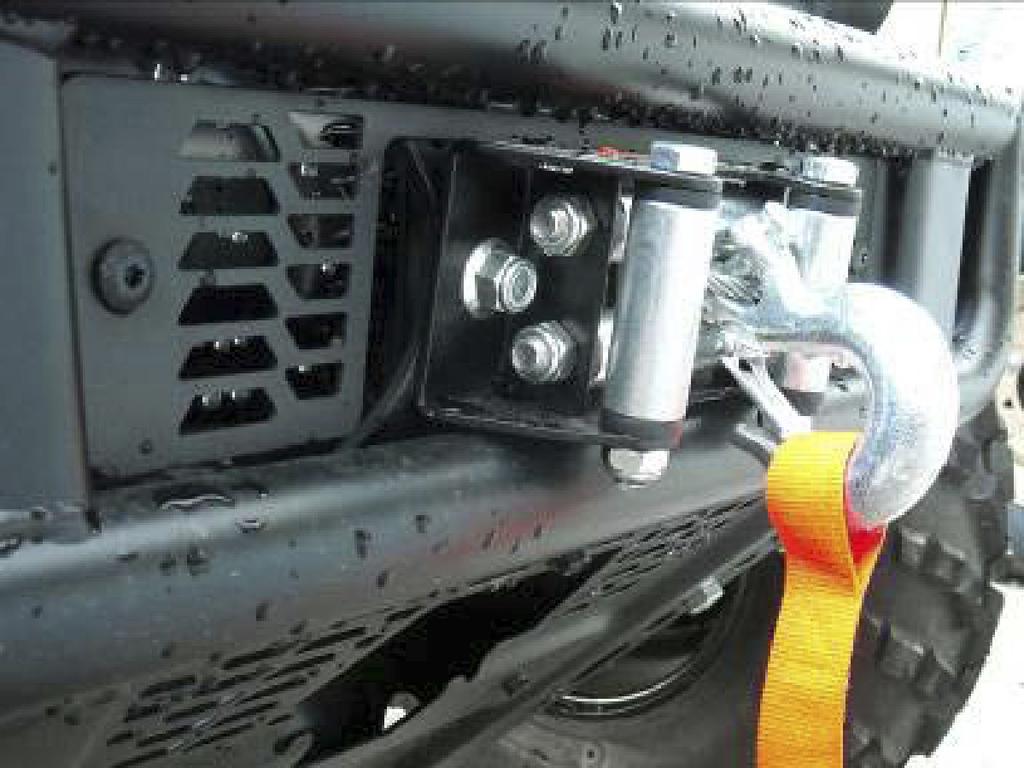 Attach winch bracket to front bumper using four M10 x 30 mm bolts, M10 nuts (not nyloc nuts) and two self-tapping bolts.