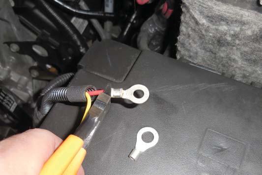 Remove the ring terminal from the red power wire end of the intercooler pump harness using a pair of wire
