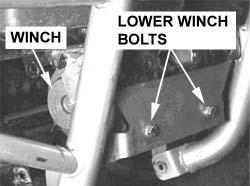 Install the winch onto the mounting bracket with the two lower bolts and lock washers, Figure 6