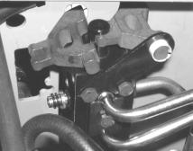 3. Remove the hex cap screw and lock nut fastening the rear valve mtg. bracket to the tractor frame (See Figure 13 or 14). Retain the fasteners. 4.