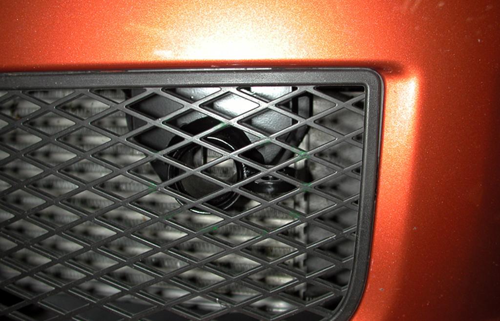 The grille on the fascia must be trimmed, in order to accommodate the two removable front bracket arms. Hold the fascia in place, over the main brace, and mark for trimming.