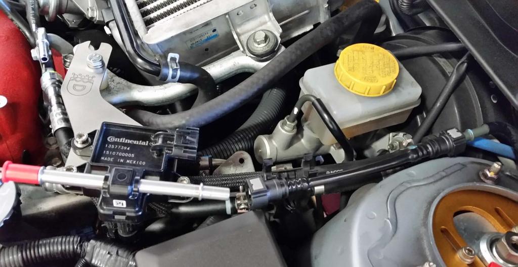 Fuel line installation: Remove the white protective caps from the fuel line and push the straight fuel line onto the OEM hard fuel line, near the firewall, push the connector until you hear an