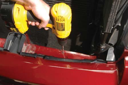 Pull the hoses off the hose barbs of the power steering cooler, and pull the cooler off the plastic tabs