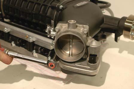 88. Install the throttle body on the new supercharger intake with the motor pointing down.
