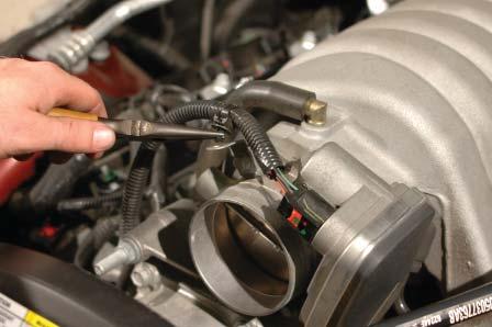 Disconnect the eight fuel injectors by pulling up on the red locking clip, then squeezing the