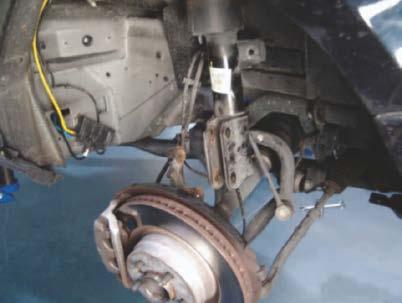 REMOVE THE TWO (2) LARGE BOLTS THAT HOLD THE STRUT TO THE SPINDLE ASSEMBLY.