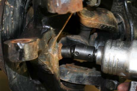 Remove the tie rod from knuckle using a 21mm socket.