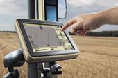 Then with the push of a button, the combine operator can control the ground speed and steering of the tractor and grain trailer to ensure smooth