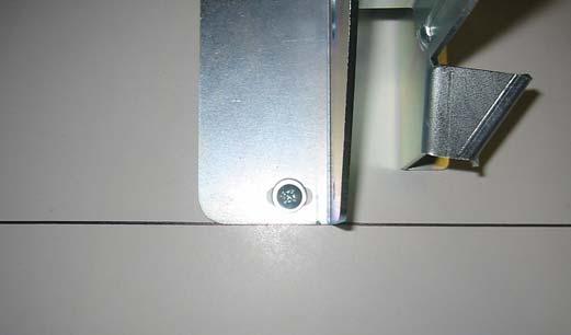 Photo #3 (Angle Bracket Alignment and Mounting) Repeat this procedure on the right bracket. Double check the alignment of the door brackets and ensure that the box structure is not bent or distorted.