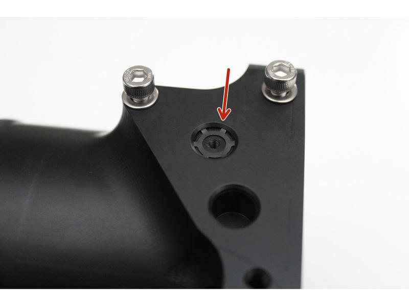 in the factory location and install the supplied plug into the port circled in ORANGE. Insert the plug with the threaded hole facing up.