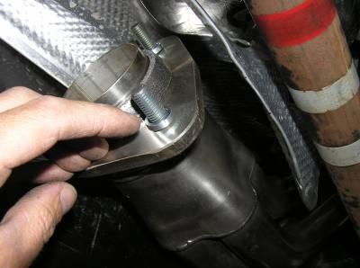 Begin with the left (driver) side catalytic converter. Slide it up into the heat shield tunnel from the rear side of the transmission cross-member.