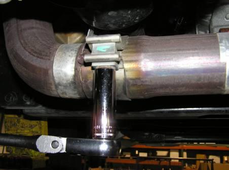 From there, loosen the clamp on the cross-over tube.