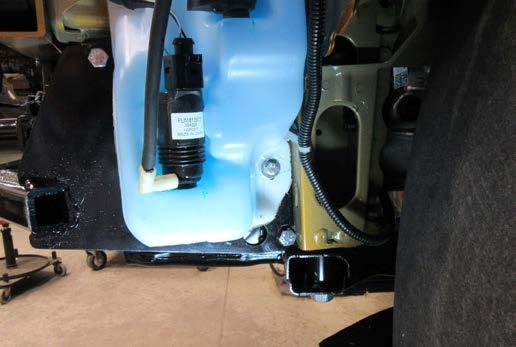 16. Reinstall the windshield washer fluid reservoir using existing hard ware except for the indicated bolt, use the 6MM bolt and 1/4 flat washer
