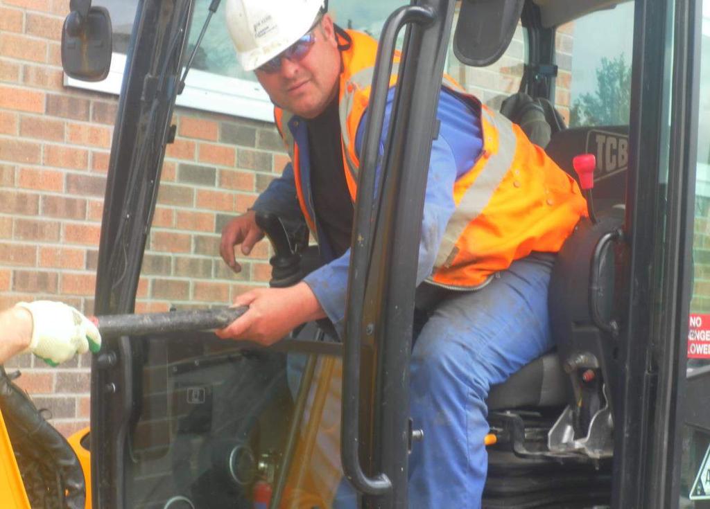 JCB Incident Operative leans forward, pushing the controls with