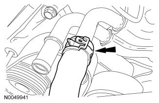 102. Connect the coolant hose from the Charge Air Cooler (CAC). 103. Install the thermostat housing assembly and the 2 nuts.