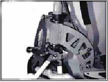 2. With one hand, depress the brake calliper using your thumb and forefinger. (Fig. 9). 3. With the other hand, adjust the tension screw on the brake line. a. Turn the tension screw clockwise to loosen the brake.