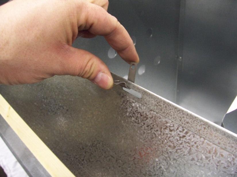 Finish riveting top panels to partitions with (2) rivets in each end partition and (1) rivet in each middle partition.