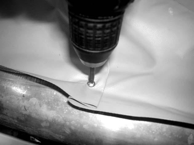 Using the provided sheet metal screws, attach the center of the cover to the center hole of the drum.