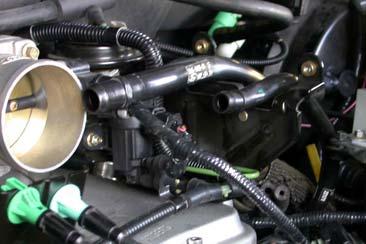 Connect coolant hose (removed from passenger side front of engine) to hose attached to rear of passenger side runner.