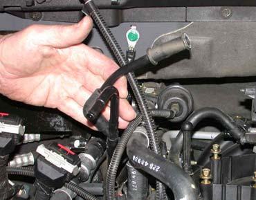 Using a 1-1/4 wrench disconnect the EGR tube from the EGR valve and loosen the other end to swing it out of the way to allow removal of the