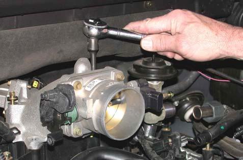 Figure 19 19. Loosen 4 bolts retaining throttle body adapter.
