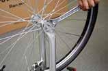 Also, you may need to adjust the saddle to make it more stable. Place the wheel between the forks.