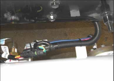 Bundle and zip tie all es together. Continue the jumper to the rear and drop it down close to the RH tank solenoid and level sender connections. Figure 32