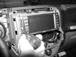 Pull the radio/instrument bezel straight back and remove from dash. Fig. 5 7.