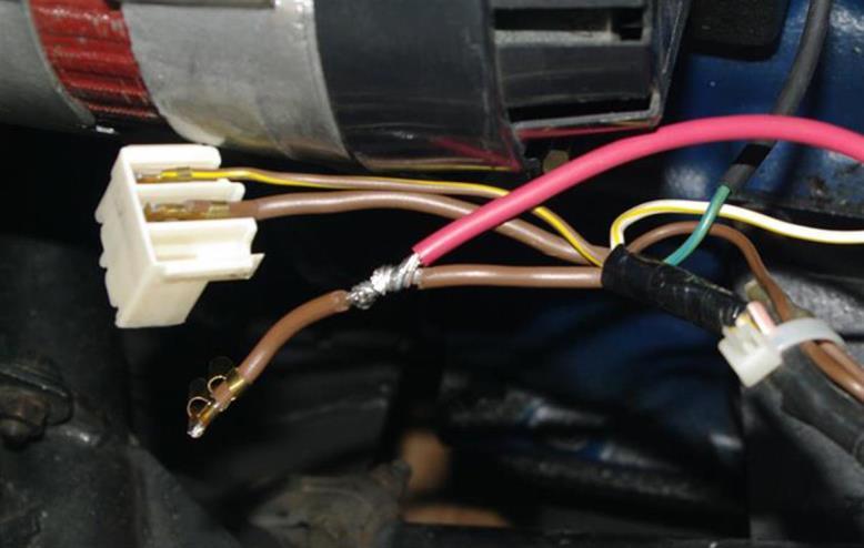 For this connection I pealed the insulation off the brown wire and soldered the new red wire onto the brown one (Figure 5). I was then careful to heat shrink and tape this joint. Figure 5.