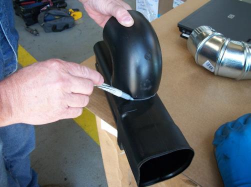Mark and cut the section of duct out allowing the elbow to slide