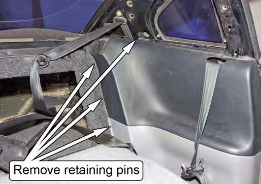 Remove the four retaining pins holding each lower plastic quarter panel in place.