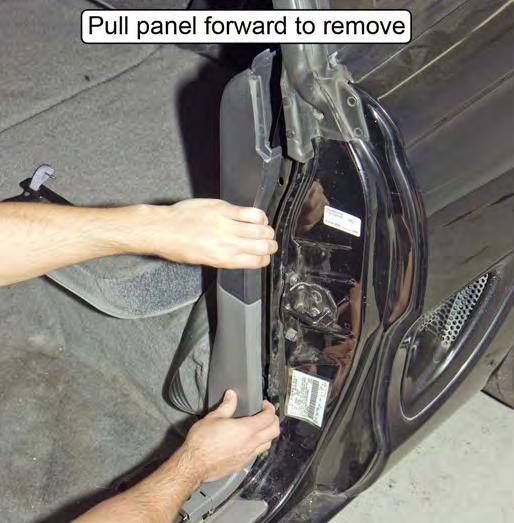 13. Remove the lower plastic quarter panels by pulling forward on the B-pillar edge. Once the panels unsnap, angle them out and over the rear seat bulkhead.
