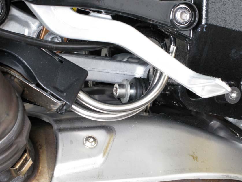 Unscrew the market bolt on both sides of the motorcycle and remove the stock exhaust off the