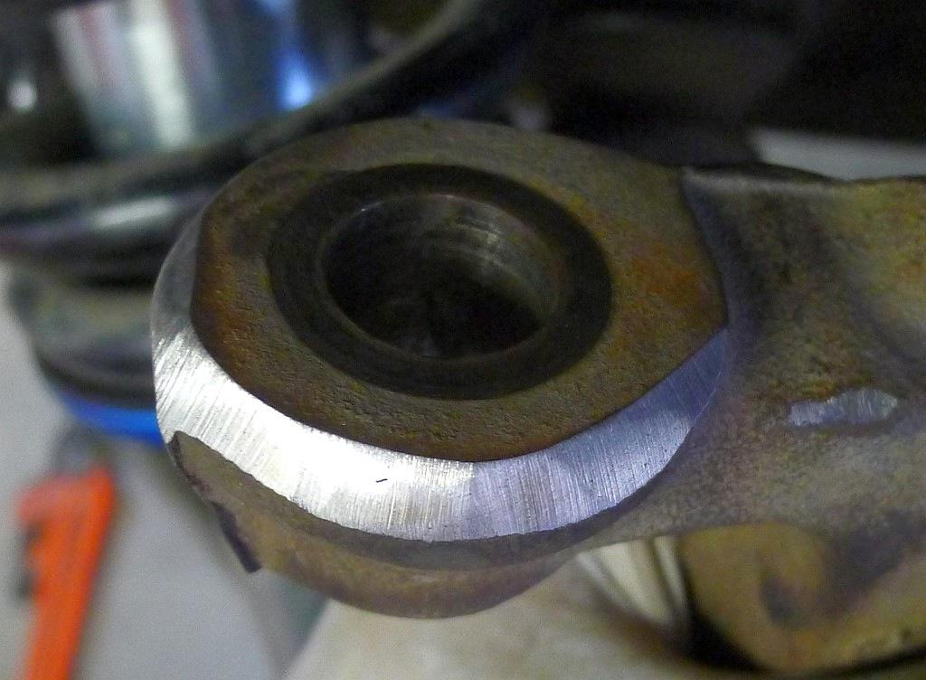 Stock Shock removal. - loosen the lower shock nut (30mm) while holding the bolt (28mm or 1 1/16"). Note this bolt and nut are very tight from Ford. 406 Ft-lbs.