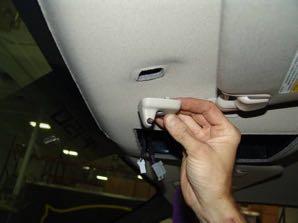 Remove both sun visor anchors (either side of roof console) by removing