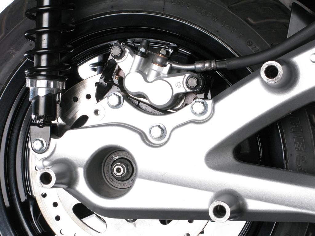 Loosen the marked link pipe clamp, unscrew the marked muffler bracket bolts and carefully remove the stock