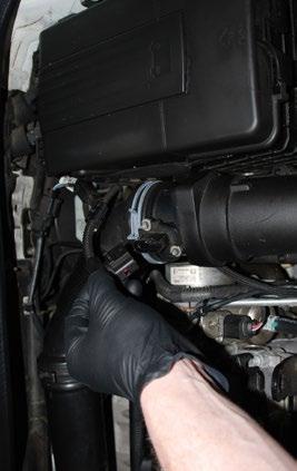 REMOVING THE STOCK DOWNPIPE - TSI Step 7: Remove the engine cover by carefully lifting upwards one corner at a time, then set the engine cover