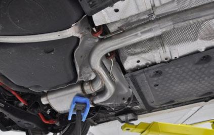 Insert the brackets into the rubber hangers (arrows), then support the muffler from below with jack stands or similar