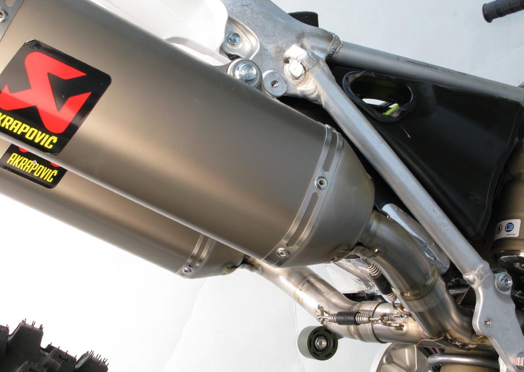 Align the mufflers in respect to the motorcycle and tighten the mufflers onto the sub frame, using bolts and washers from