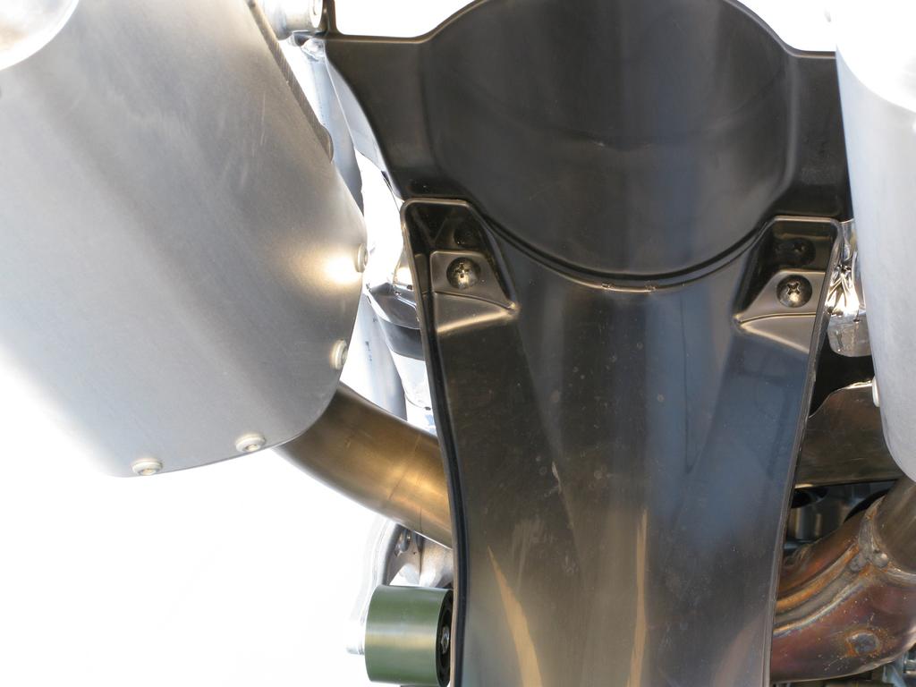 Unscrew the marked bolts on both sides of the motorcycle and remove the seat and both side panels (Figure 1).