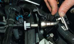 29. Remove the fuel line from the fuel rail by first prying
