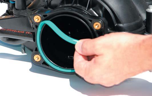 Move the automatic transmission fill tube by pulling it firmly outward towards the fender of the