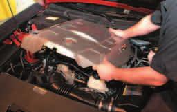 29. Pull up firmly at the front and back of the engine cover to remove it. It will not be reused. 30.