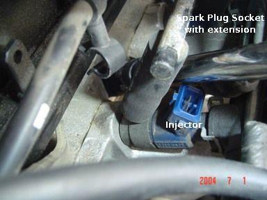 Here is how close the spark plug socket went in between the injector and the intake manifold: STEP 5 (plug #1): This is the
