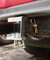 Slide the reverse anti-tilt bracket (S) forward toward the vehicle hitch until it is flush against the hitch. Tighten the four bolts on the anti-tilt bracket.