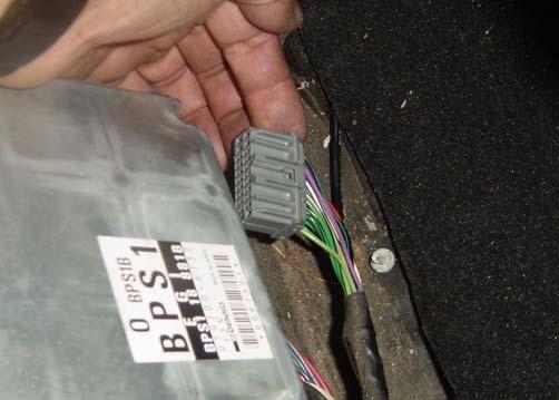 Pull the fasteners that hold the carpet and then pull the carpet up and back to access the ECU as shown in Photo C-1.